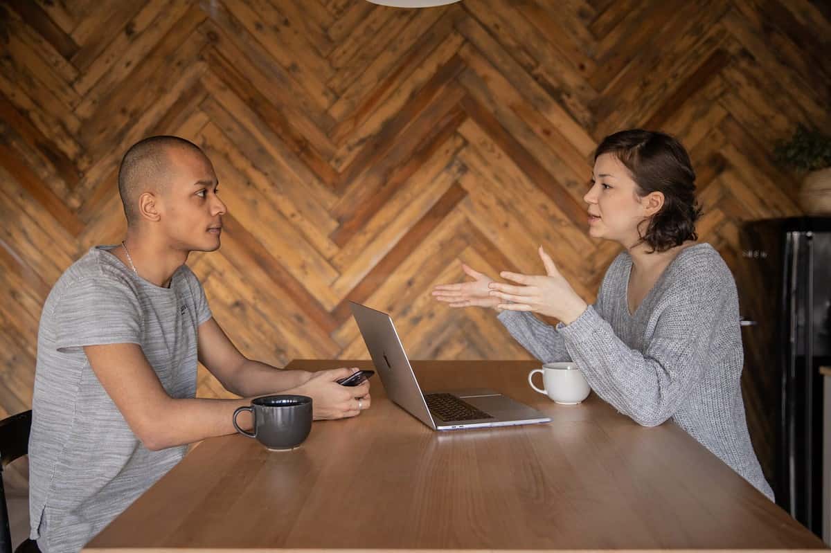 Two people sharing a coffee and having a conversation.